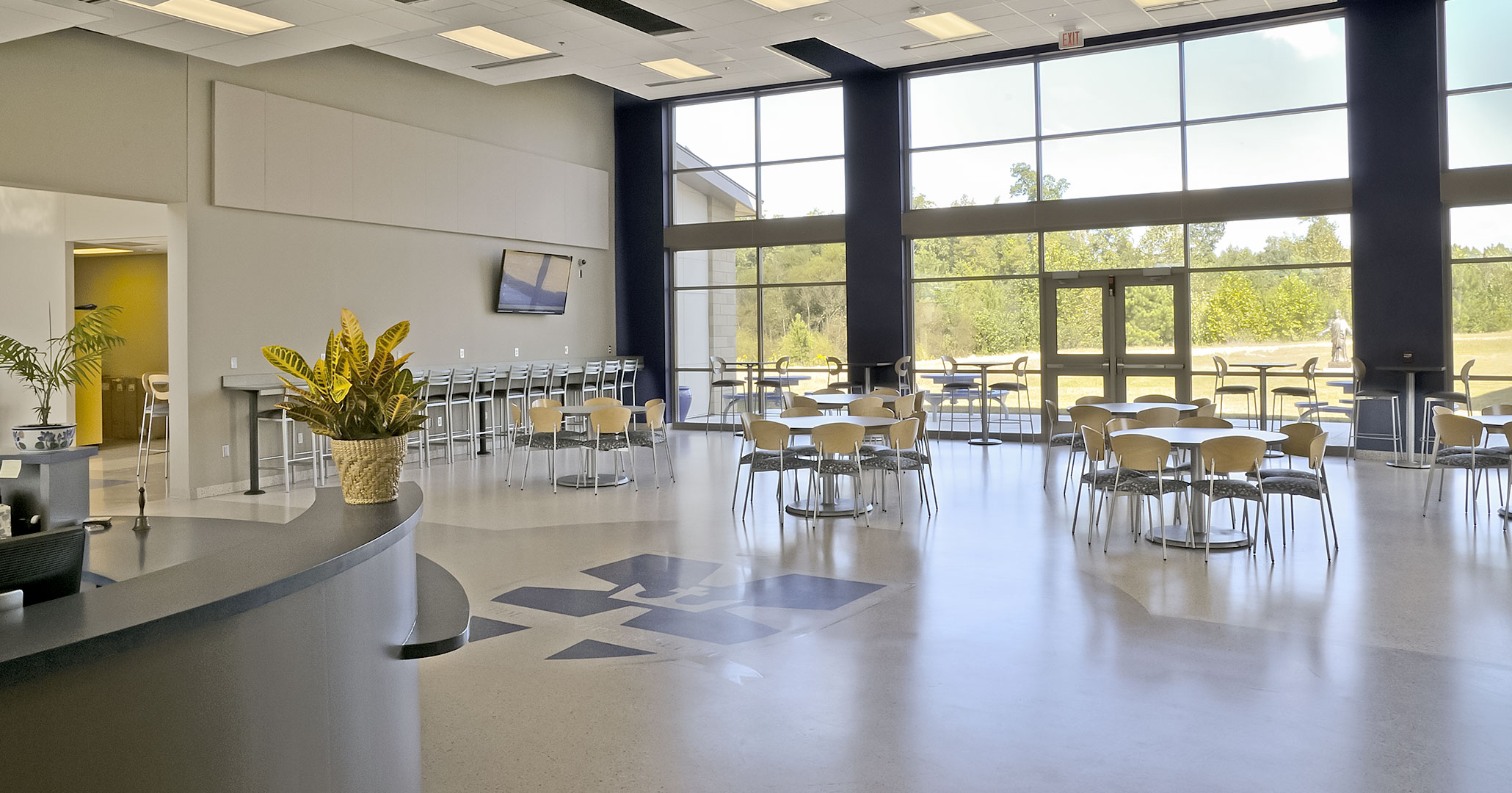 The Charlotte Diocese and Christ the King Catholic High School worked with Boudreaux master planners and architects to design an open modern entry where students gather to study.