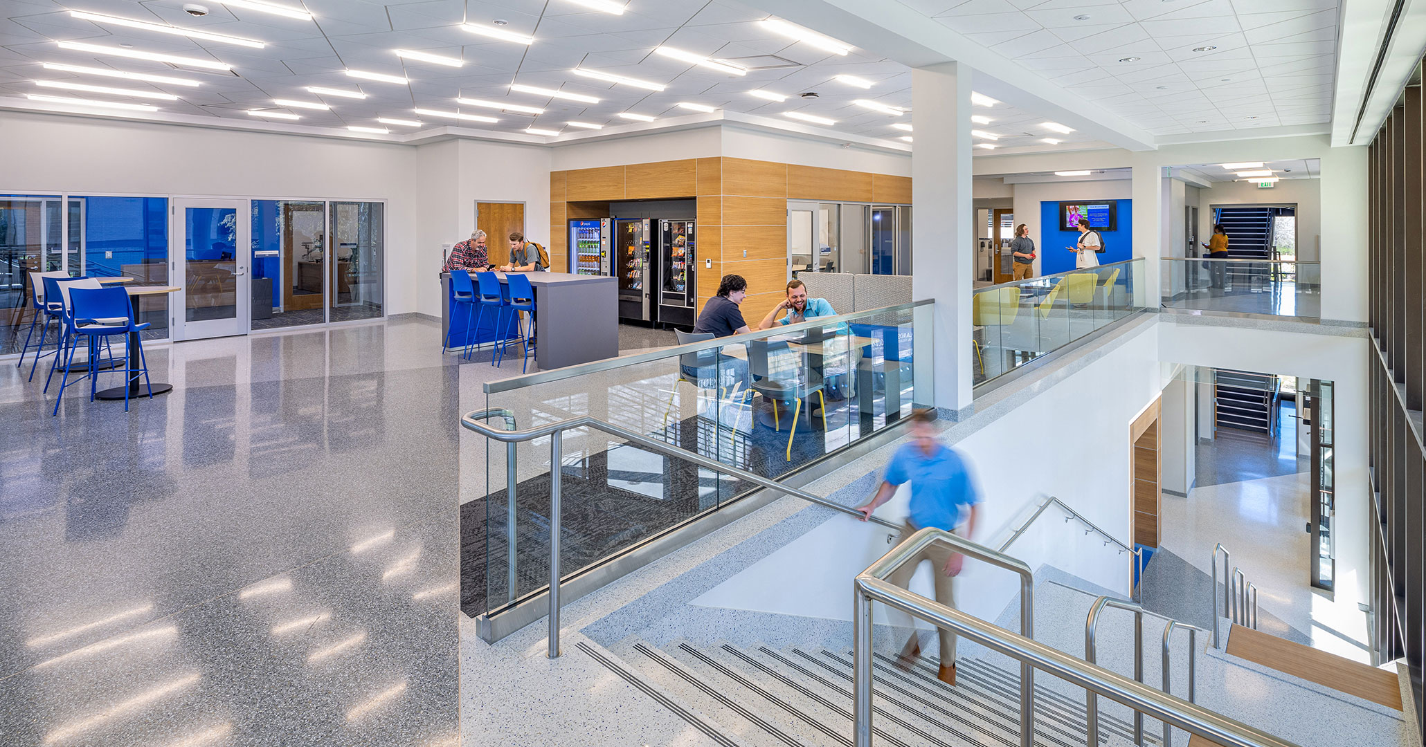 BOUDREAUX architects designed an open student community space that spans two floors and encourages students to stay on campus